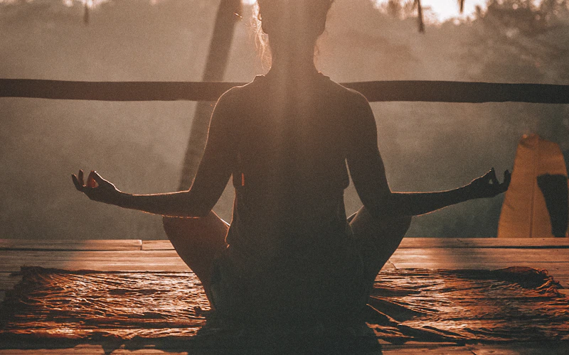 Person practicing mindful meditation outdoors